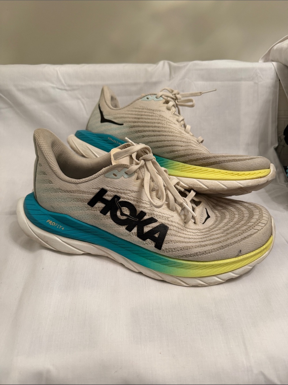 Hoka Beige Running Shoes with Teal and Yellow Accents